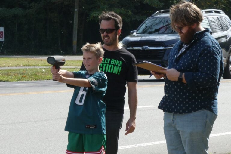a child holds a radar gun