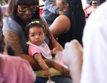 A woman holding a baby
