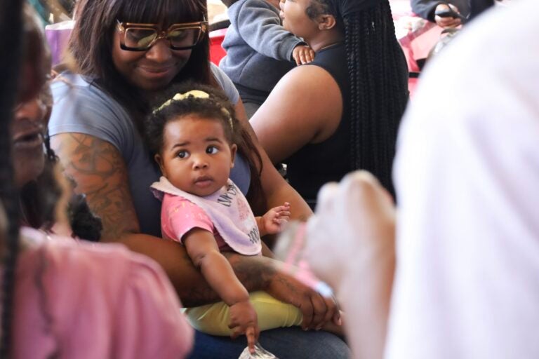 A woman holding a baby