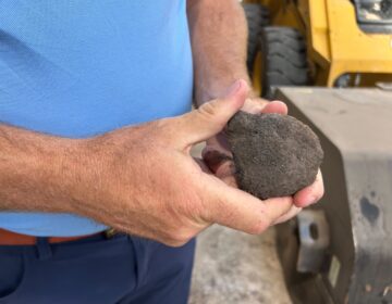 A man holding a piece of biocoal