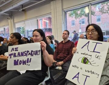 Technology justice activists held up signs