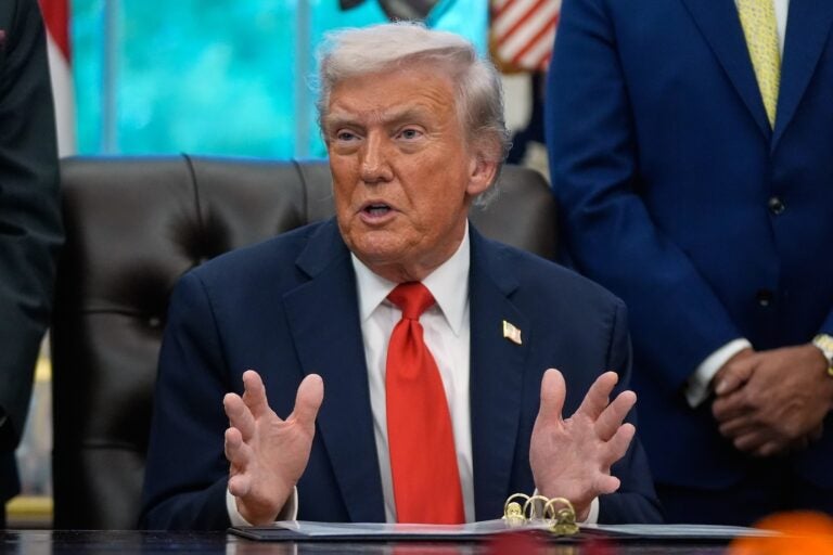 President Donald Trump answers questions from reporters