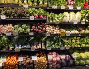 A stocked produce aisle at a supermarket