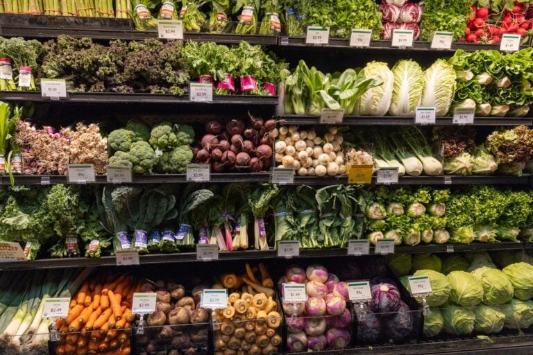 A stocked produce aisle at a supermarket