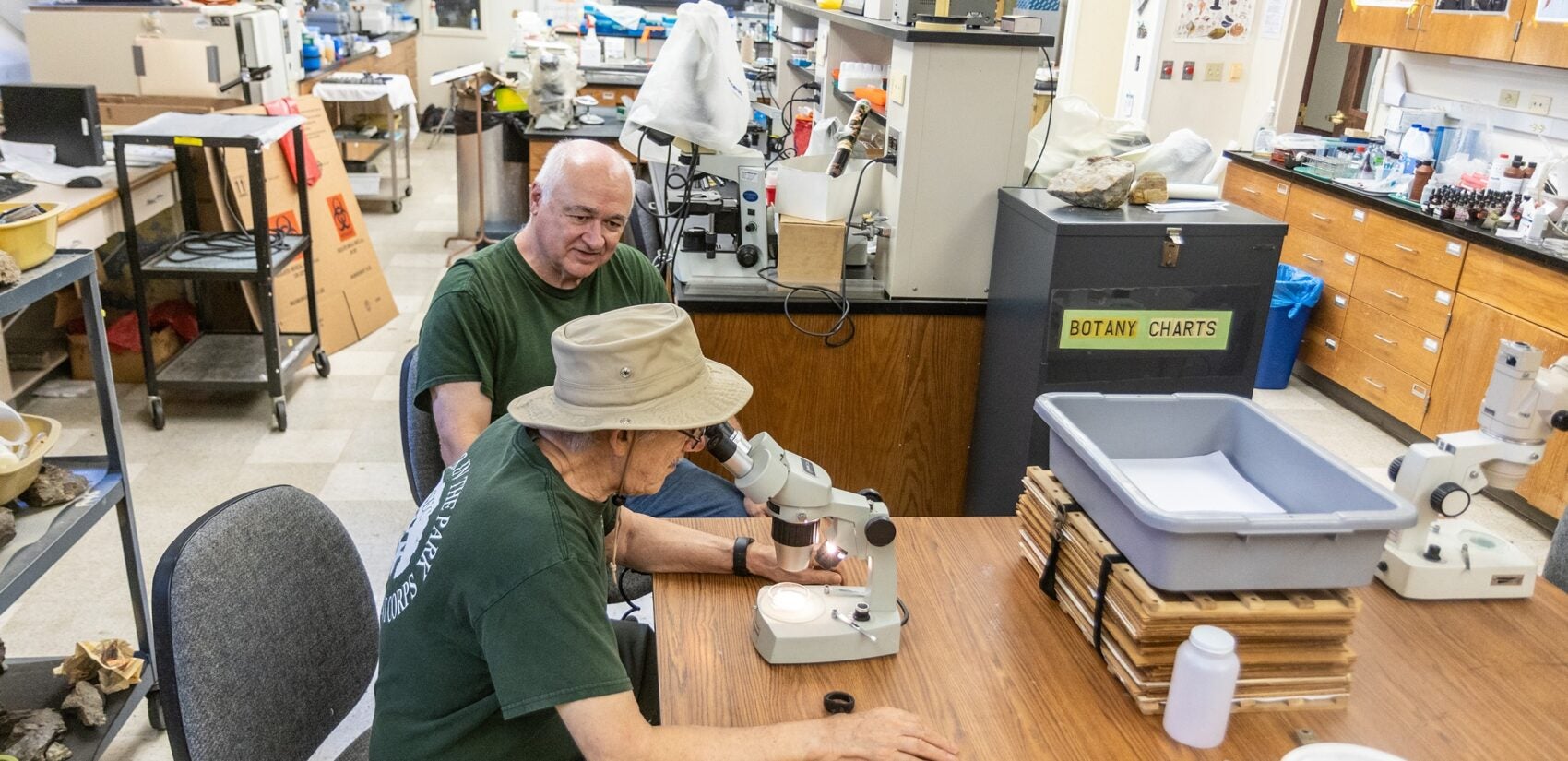 Bob Meyer and David Schogel with a microscope