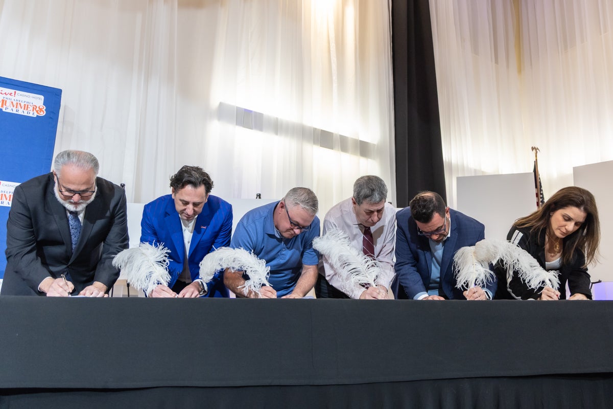 Mummers officials and sponsors ceremoniously sign with WFMZ to air the Philadelphia Mummers Parade until 2028 at a press conference