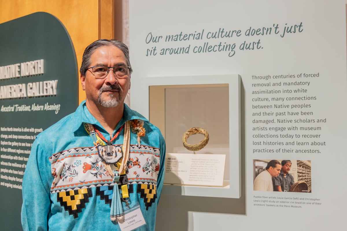 Christopher Lewis stands with his artwork at Penn Museum