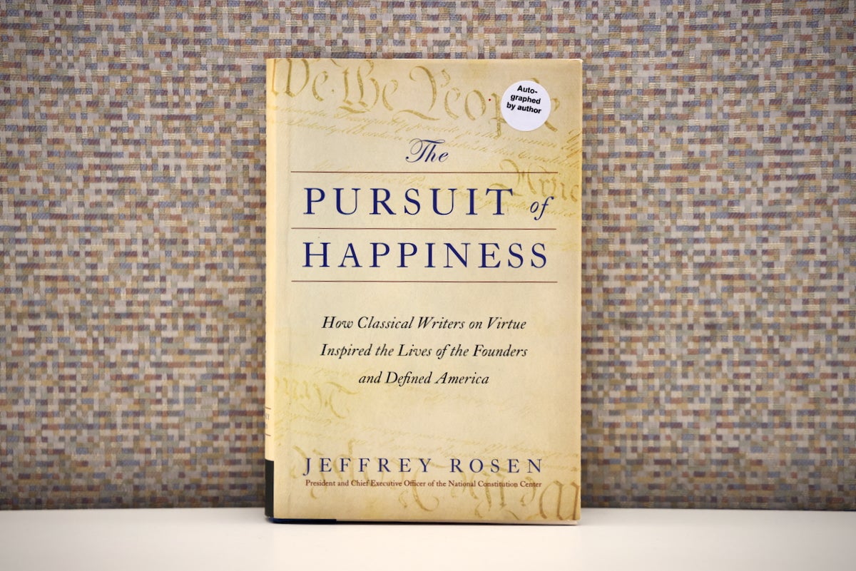 a copy of The Pursuit of Happiness by Jeffrey Rosen