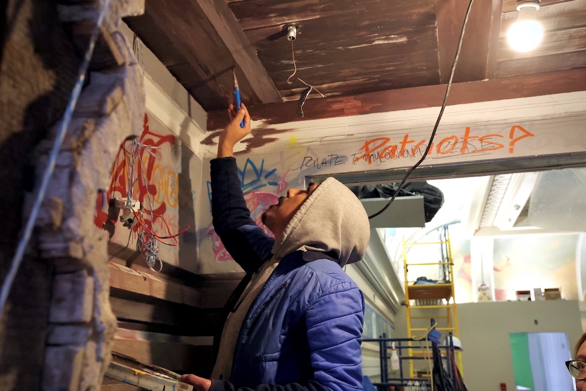 José Lemus painting a mural in the ''Ministry of Awe'