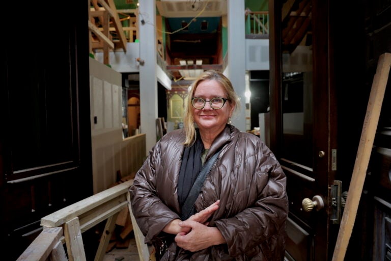 Meg Saligman stands at the entrance to Manufacturers National Bank