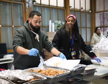 Prevention Point Philadelphia staff members Carlos Del Valle and Amira Cason put together hot meals for the nonprofit's annual community 