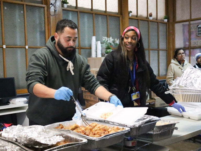 Prevention Point Philadelphia staff members Carlos Del Valle and Amira Cason put together hot meals for the nonprofit's annual community 
