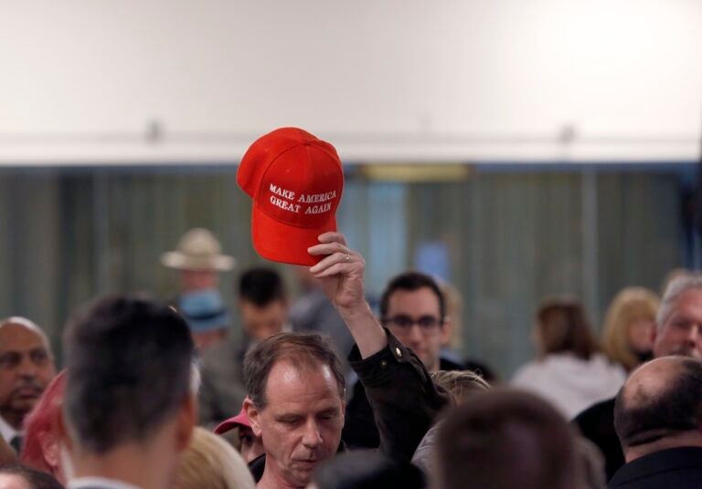 A member in the audience holds up a 