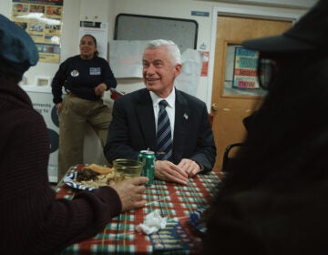 Jersey City mayoral candidate Jim McGreevey, center, listens during a community event