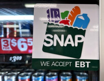 Government Shutdown Food Aid SNAP EBT information sign is displayed at a gas station
