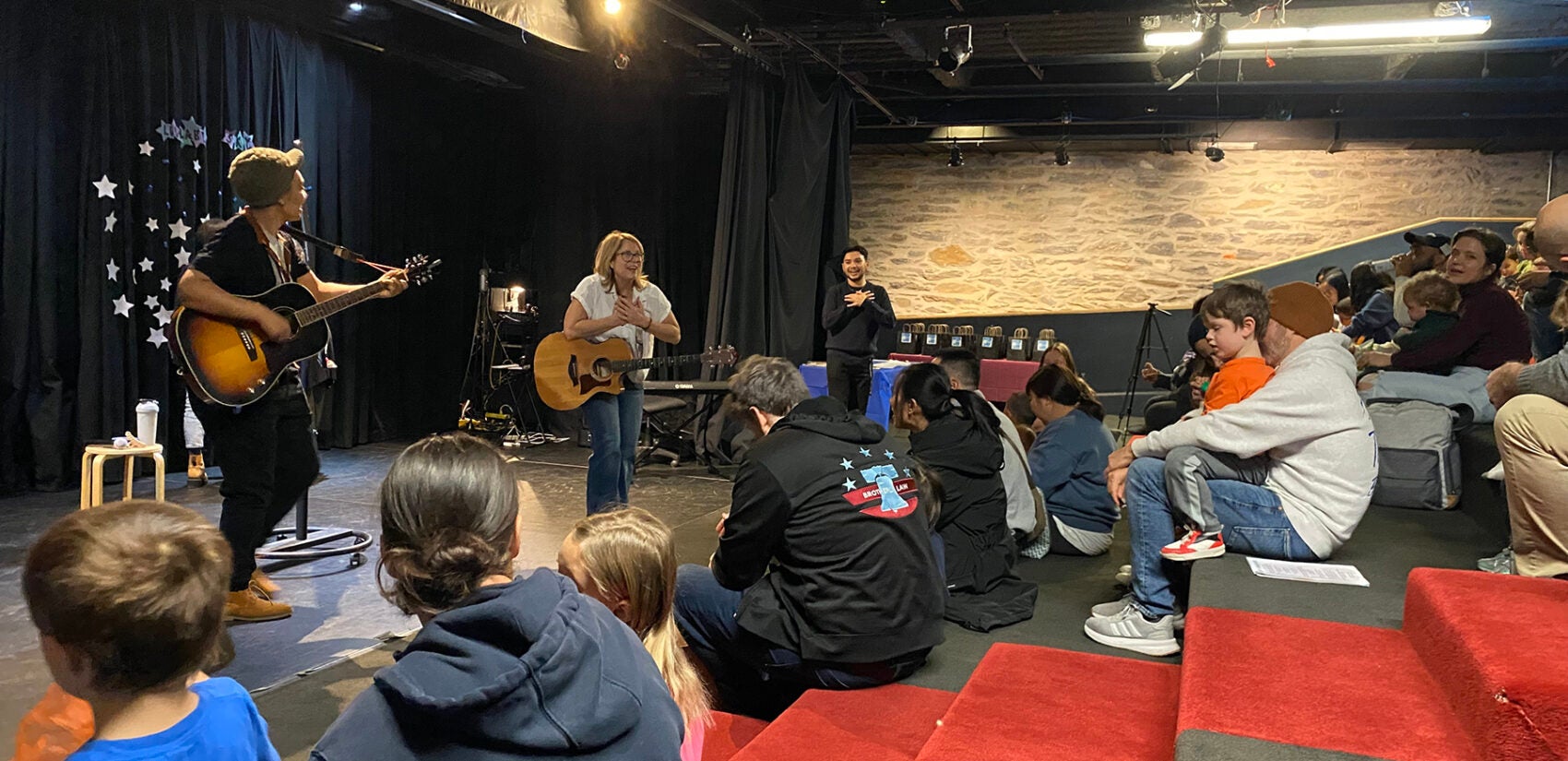 Professional musicians lead a songwriting workshop with kids and families at the Please Touch Museum’s Wonder Theater.