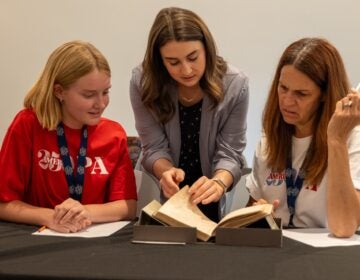 PAHistoricalSociety-12-250-scholarship-philadelphia Three people looking at a book