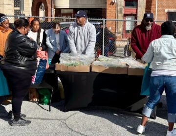 Wilmington-YMCA-food-2025-11-06-1 Volunteers hand out fresh produce and other groceries at a food giveaway event at the Wilmington YMCA