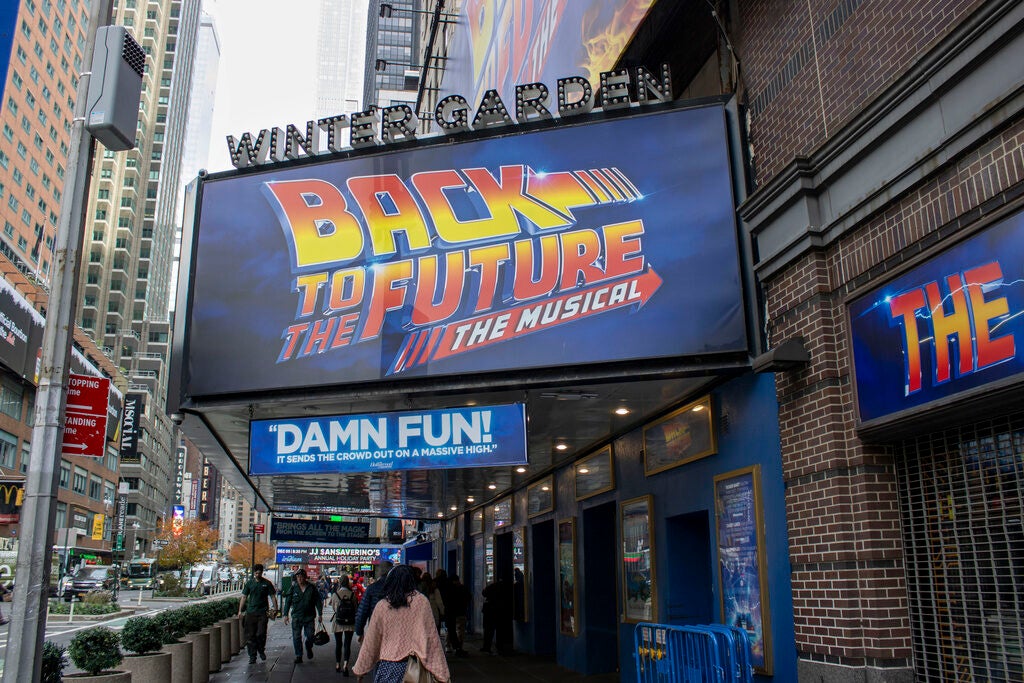 The "Back to the Future: The Musical" title displays on a sign on Broadway