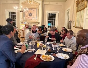 breaking bread pilot 5 People sitting around a large round table eating