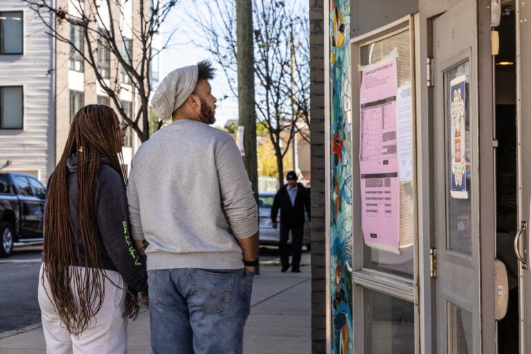 Voters review the ballot before heading into their polling place in Philadelphia’s South Kensington neighborhood on Election Day,