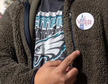 A voter shows off their election sticker in Philadelphia