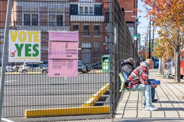 Campaign workers wait to hand out flyers to people going to vote in Philadelphia’s South Kensington neighborhood