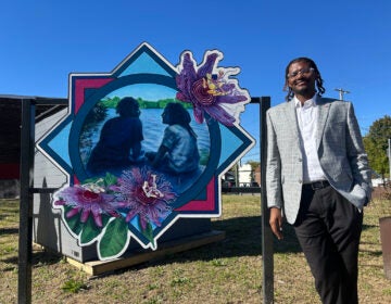 elmwood-avenue-philadelphia-dumpster3 Isaiah T. Martin, Empowered CDC’s president and CEO, stands next to a piece of artwork at the nonprofit's first community waste disposal site near Bartram's Garden.