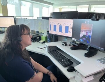 Virtua registered nurse Rachel Schlichtmann checks in remotely with a patient at a computer