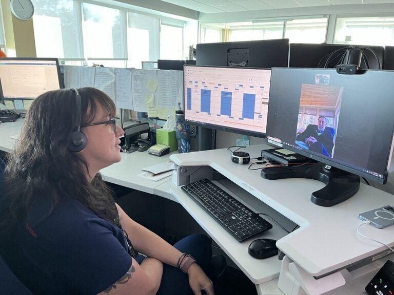 Virtua registered nurse Rachel Schlichtmann checks in remotely with a patient at a computer