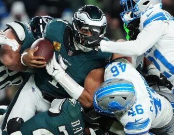 Lions Eagles Football Philadelphia Eagles quarterback Jalen Hurts (1) is stopped with the ball during the second half of an NFL football game by Detroit Lions linebacker Jack Campbell (46) and Lions cornerback Amik Robertson (21) Sunday, Nov. 16, 2025, in Philadelphia.