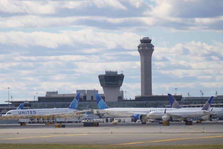 Planes in front of air traffic control tower at Newark International Airport