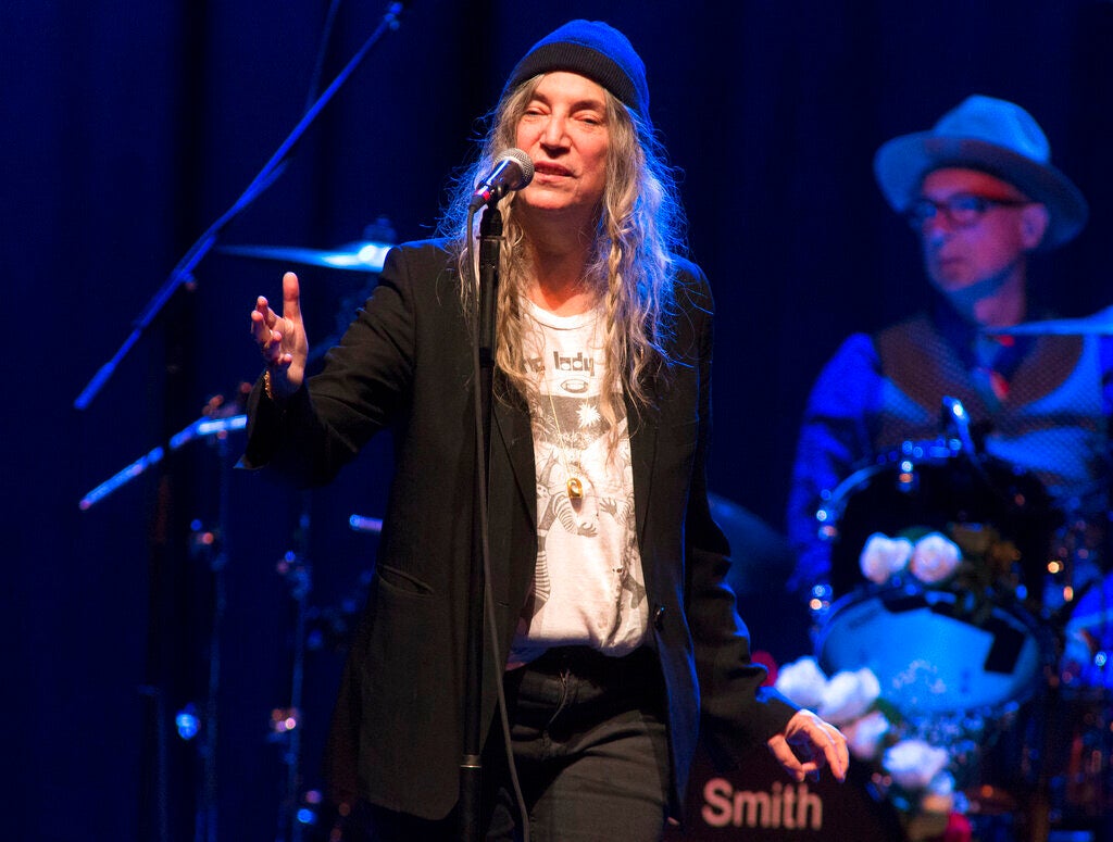 Patti Smith performs in concert at The Met in Philadelphia, singing into a microphone