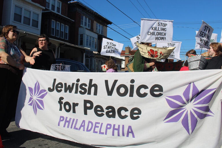 People hold a sign that reads 