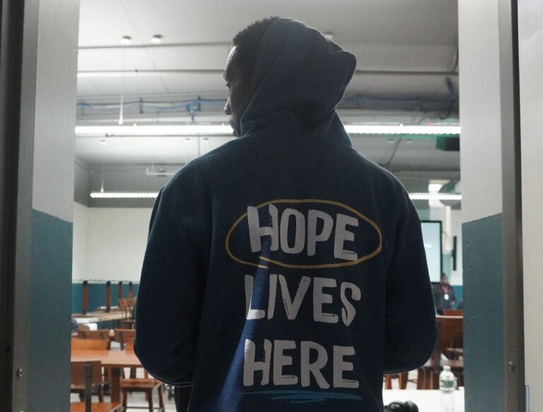 A member of Philly House's staff prepares to serve food