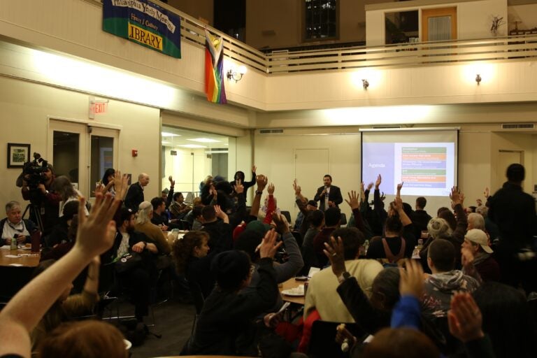Dozens of transit advocates raising their hands