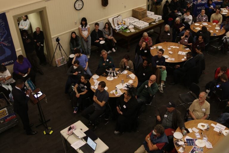 Dozens of transit advocates sitting down