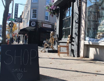 A chalkboard sign on the sidewalk reads 