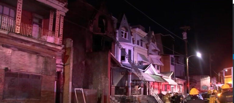 Firefighters and emergency personnel are gathered outside of a home in Philadelphia