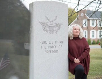 Gail Nazarene next to a monument reading HERE WE MARK THE PRICE OF FREEDOM