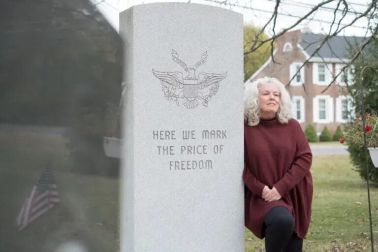 Gail Nazarene next to a monument reading HERE WE MARK THE PRICE OF FREEDOM