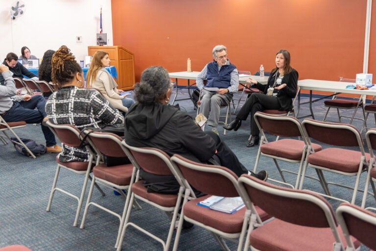 David Matthau and Brandi Harding sitting and addressing people sititng in the audience at the resource fair