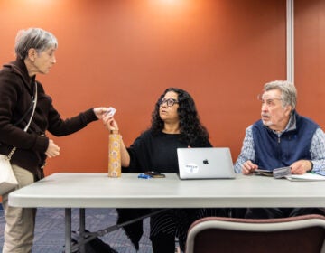 Madhu Bora and David Matthau speaking with an attendee at the resource fair