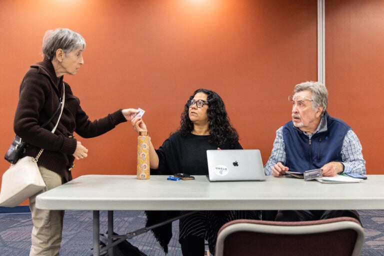 Madhu Bora and David Matthau speaking with an attendee at the resource fair