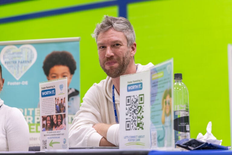 Joesph Balinski sitting behind the information table at the resource fair