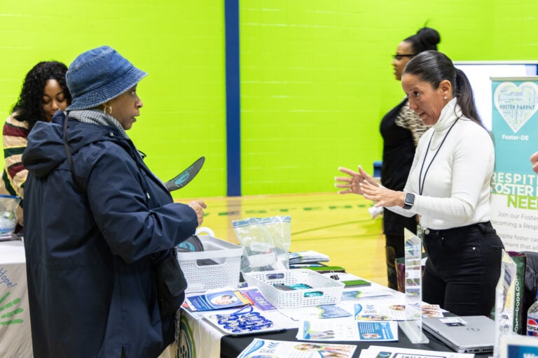 Chandra McDougale speaks with a representative from one of the organizations at the resource fair
