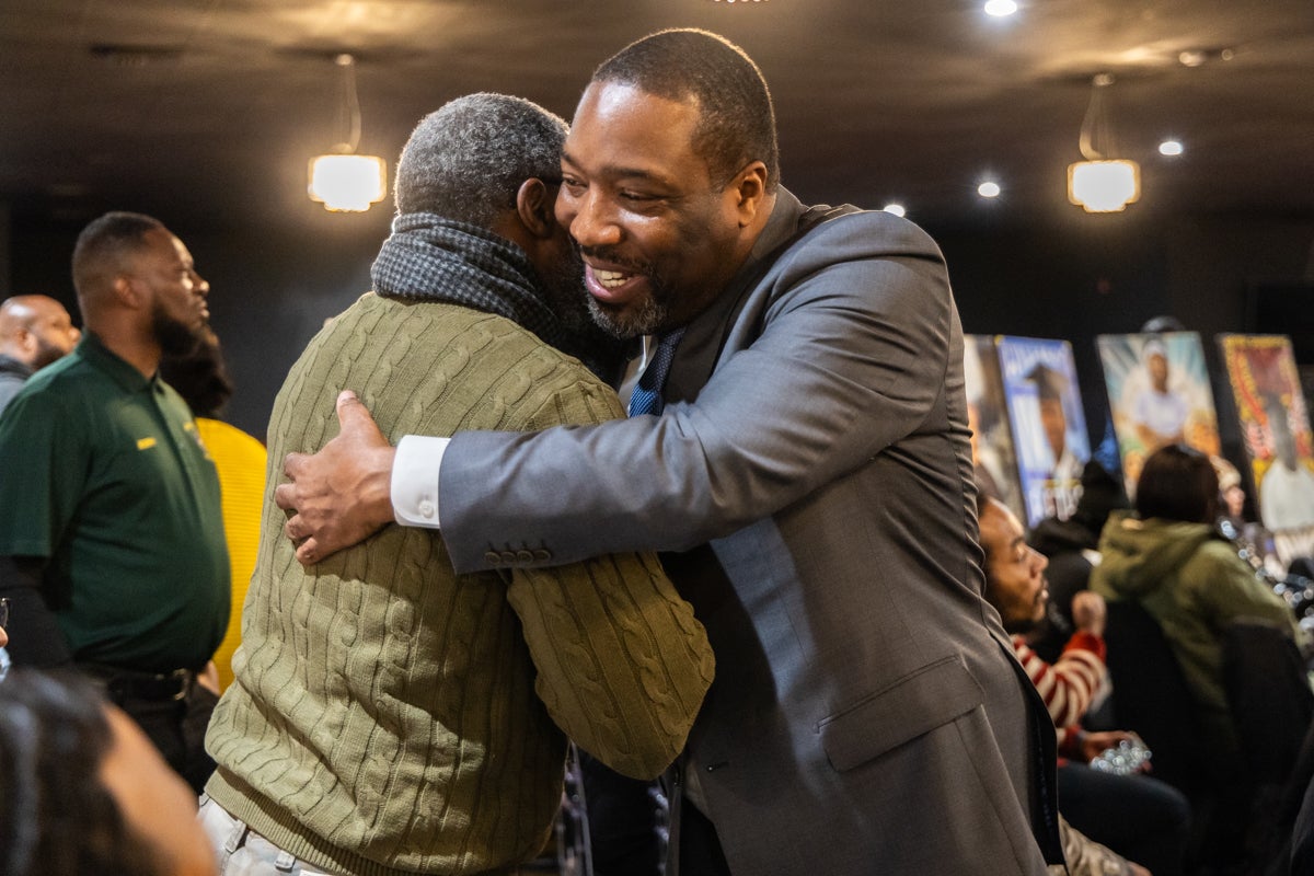 Philadelphia City Council President Kenyatta Johnson hugs a man