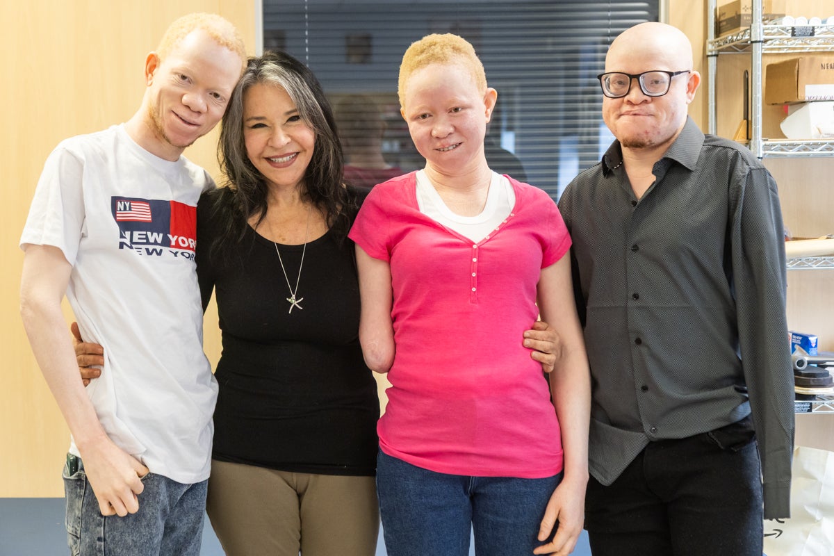 Mwigulu, Pendo and Emmanuel pose for a photo with Elissa Montanti