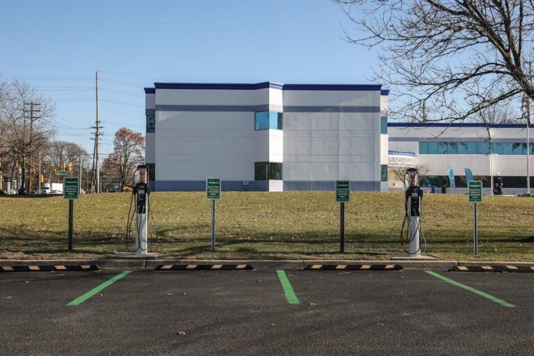 A parking lot with EV chargers in front of two spaces