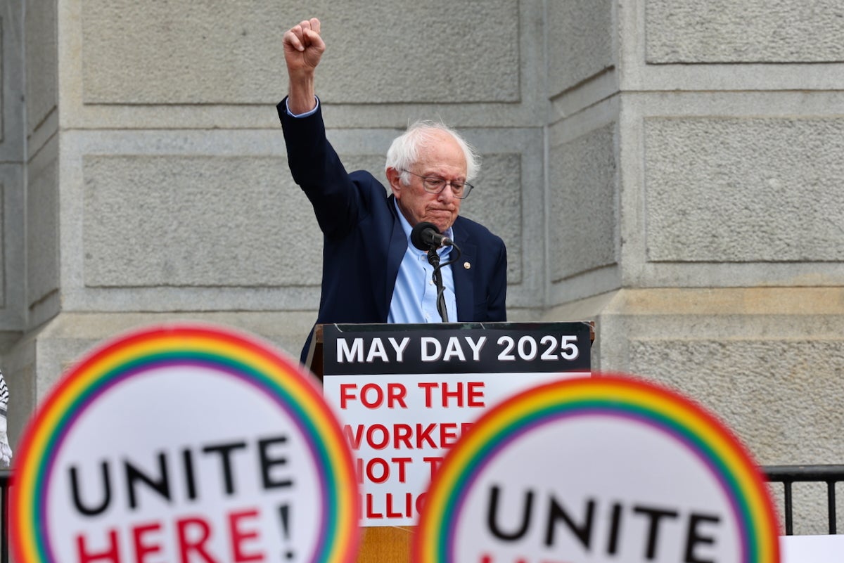 Vermont Sen. Bernie Sanders raises his fist in the air as he speaks at a podium during a May Day rally outside of Philadelphia City Hall on May 1, 2025.